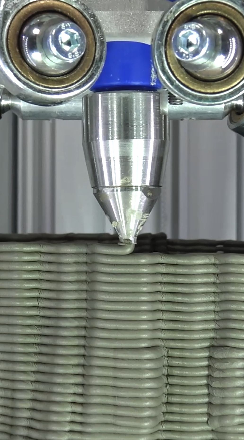 Close-up of clay being extruded layer by layer